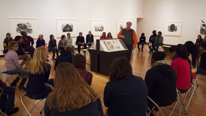 Museum director John Stomberg speaks to a class about the Kara Walker exhibition.