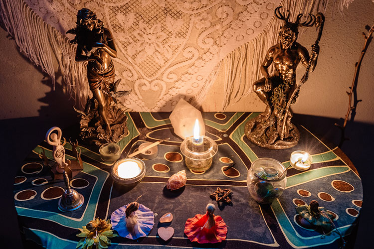 Figurines and candles on a colorful tablecloth