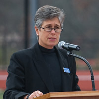 Laurie Priest standing at podium