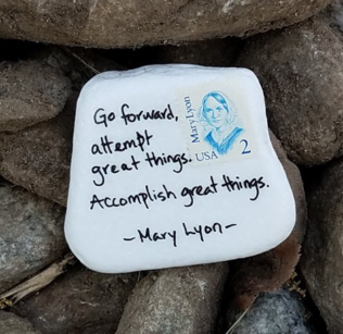 A rock painted white with a Mary Lyon two cent stamp quotes the founder: "Go forward, attempt great things. Accomplish great things."
